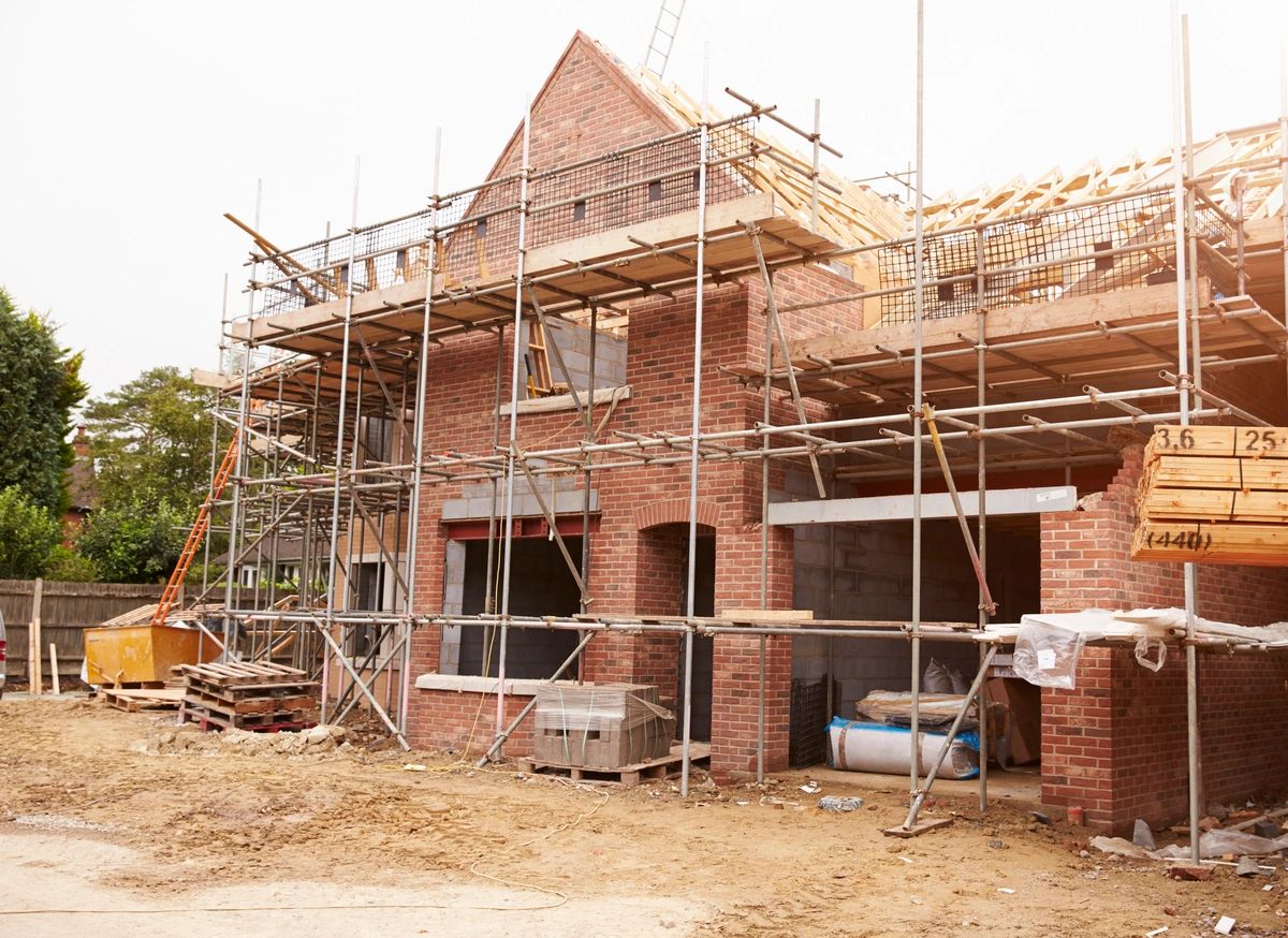 A brick house with scaffolding around it.