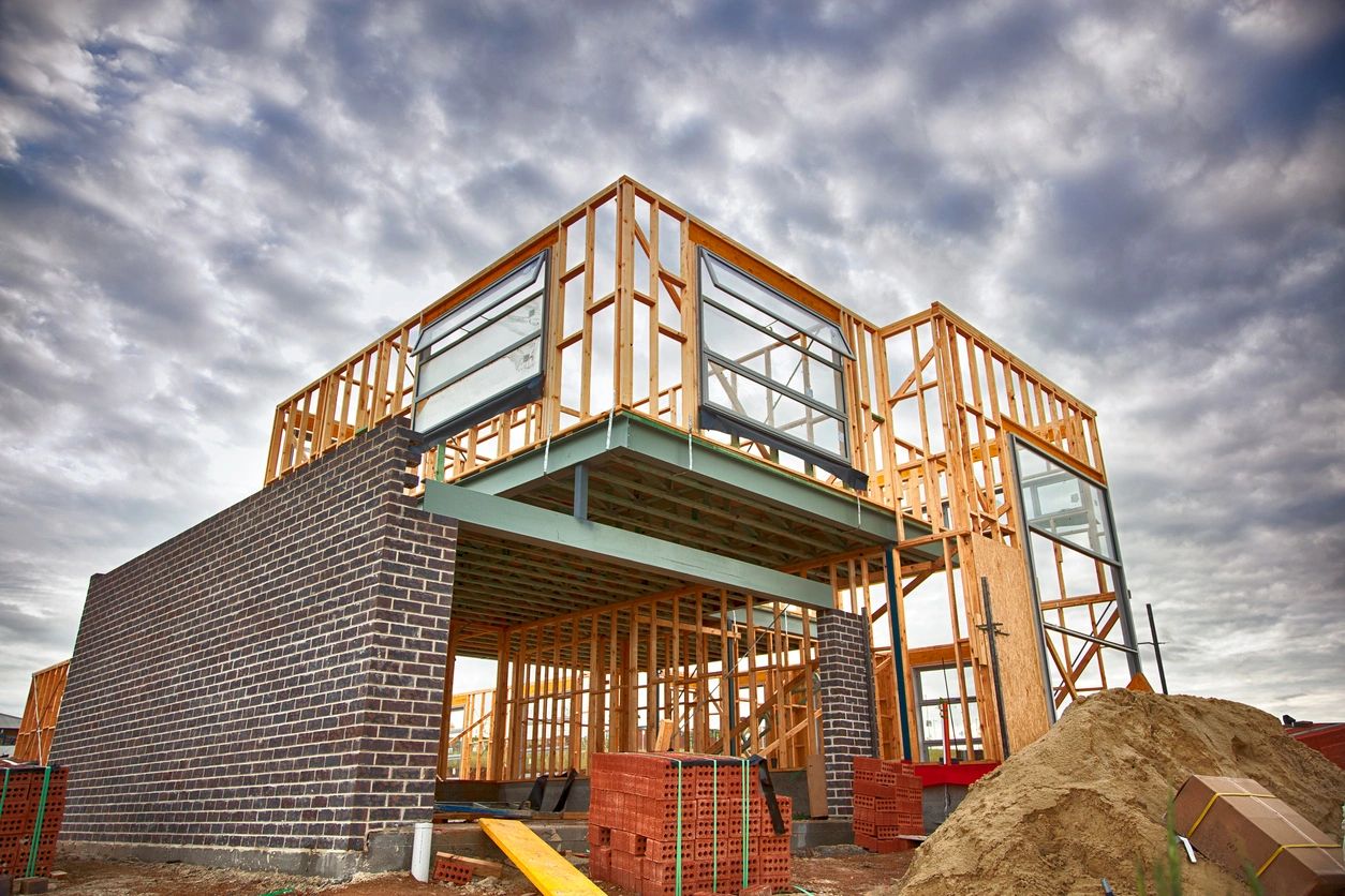 A building under construction with some wood and brick.